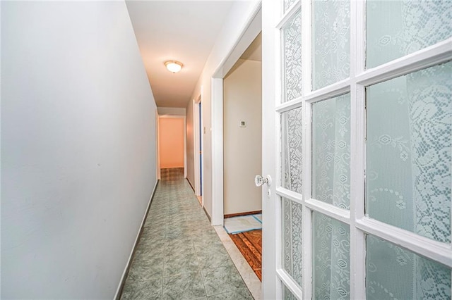 hall featuring baseboards