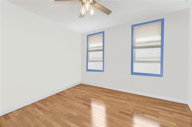 unfurnished room featuring baseboards, ceiling fan, and light wood finished floors