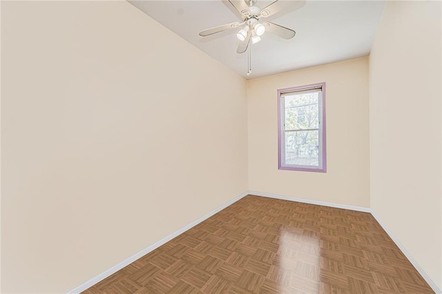 spare room with baseboards and ceiling fan