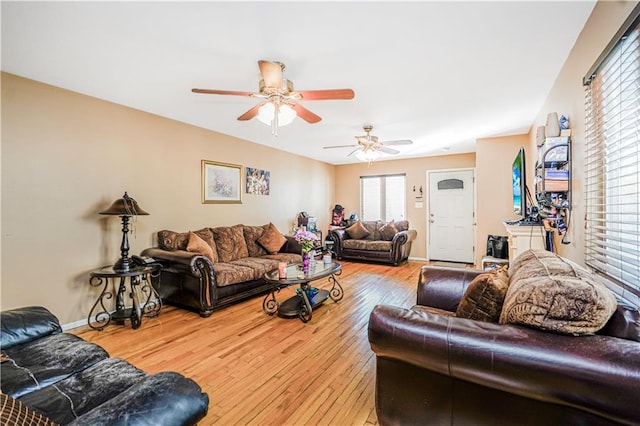 living room featuring wood-type flooring and ceiling fan