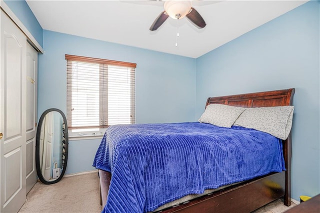 carpeted bedroom featuring a closet, baseboards, and ceiling fan
