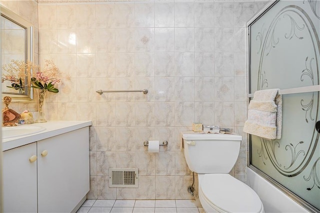 full bathroom with vanity, toilet, tile walls, and visible vents