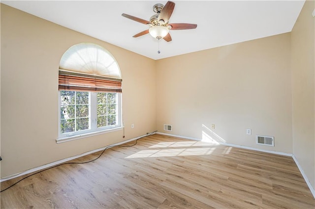unfurnished room featuring a ceiling fan, visible vents, and light wood-style flooring