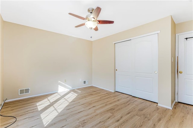 unfurnished bedroom with visible vents and light wood-style flooring