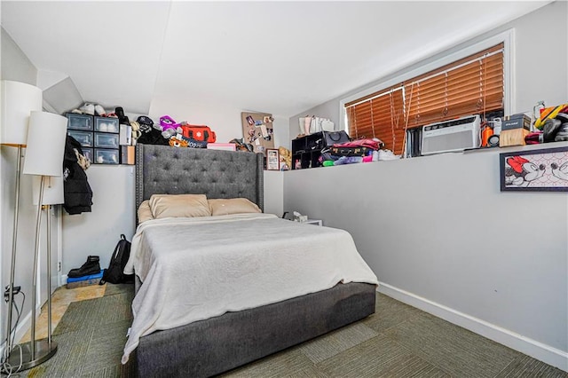 bedroom with baseboards and cooling unit
