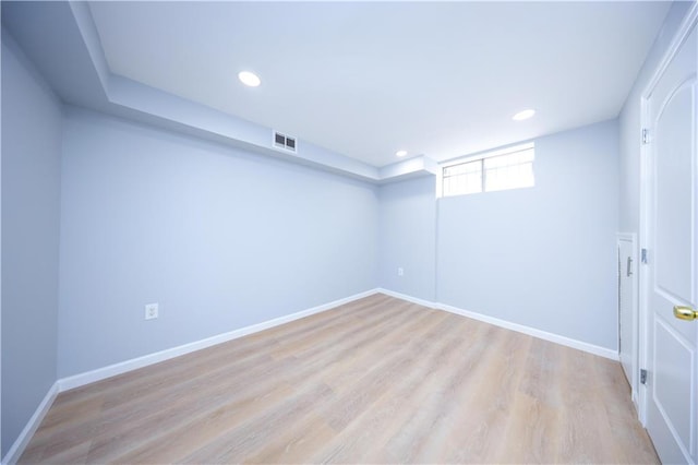 below grade area with light wood-style flooring, baseboards, and recessed lighting