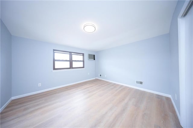 unfurnished room with wood finished floors and baseboards