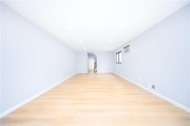 unfurnished room with light wood-style floors, baseboards, and recessed lighting