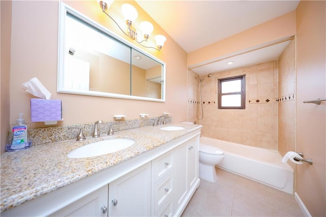 full bath with toilet, double vanity, tile patterned flooring, shower / washtub combination, and baseboards