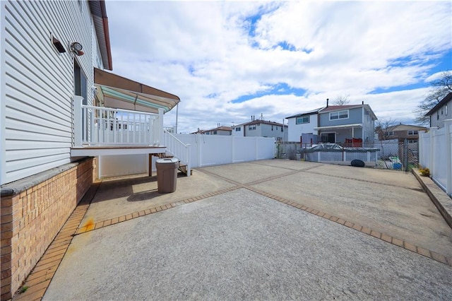 view of patio / terrace featuring a fenced backyard and a residential view