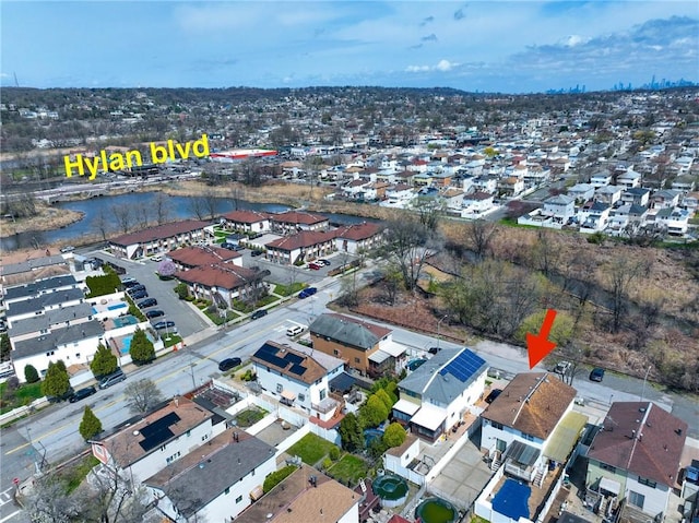 aerial view of residential area featuring a large body of water