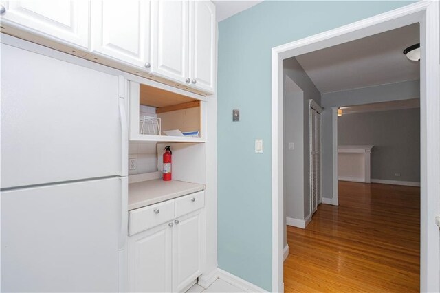 interior space with baseboards and light wood-style floors