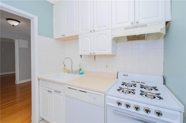 kitchen with white cabinets, a sink, white appliances, backsplash, and under cabinet range hood