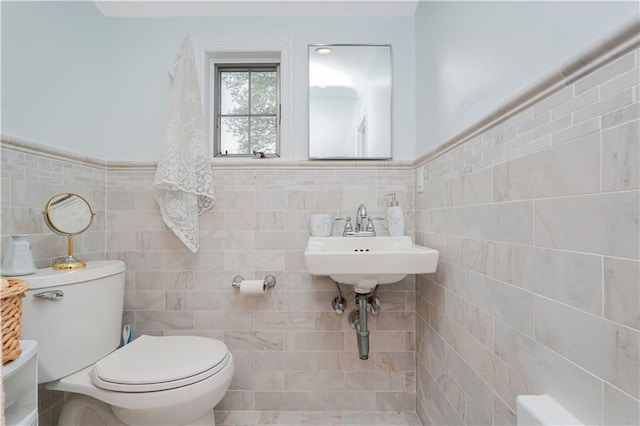 249 Slosson Ave, Staten Island, NY 10314 - bathroom with toilet, tile walls, and wainscoting