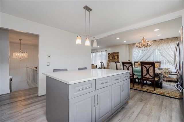 149 Forest St, Staten Island, NY 10314 - kitchen with a chandelier, light wood finished floors, a kitchen island, light countertops, and recessed lighting