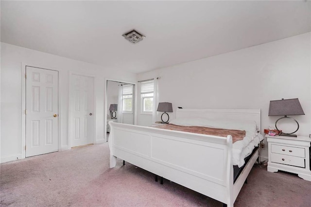 carpeted bedroom featuring baseboards