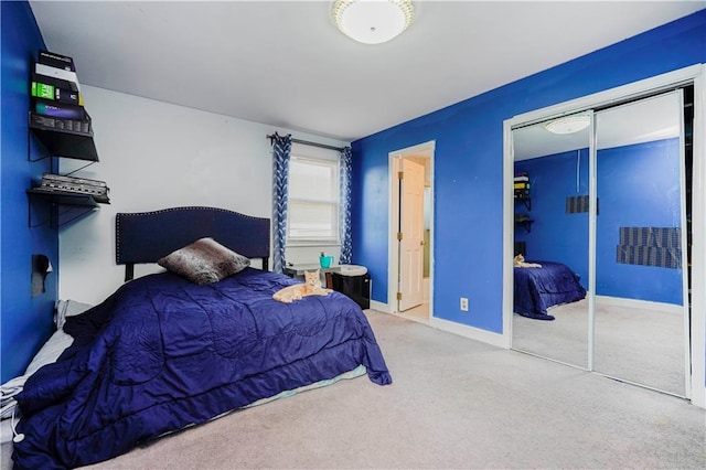 carpeted bedroom with baseboards and a closet