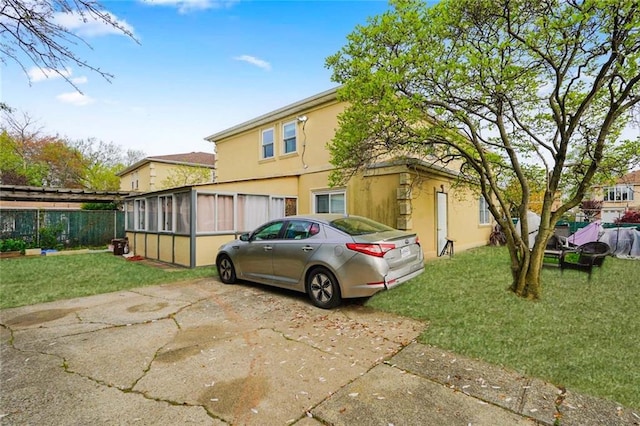 149 Forest St, Staten Island, NY 10314 - view of side of property with stucco siding and a sunroom