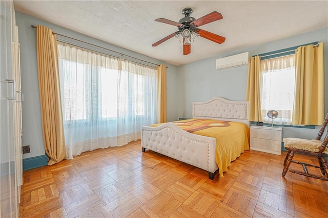 bedroom with a ceiling fan and a wall mounted air conditioner