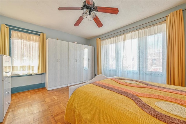 bedroom with baseboards and ceiling fan