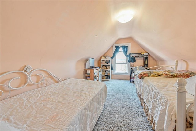 carpeted bedroom with lofted ceiling