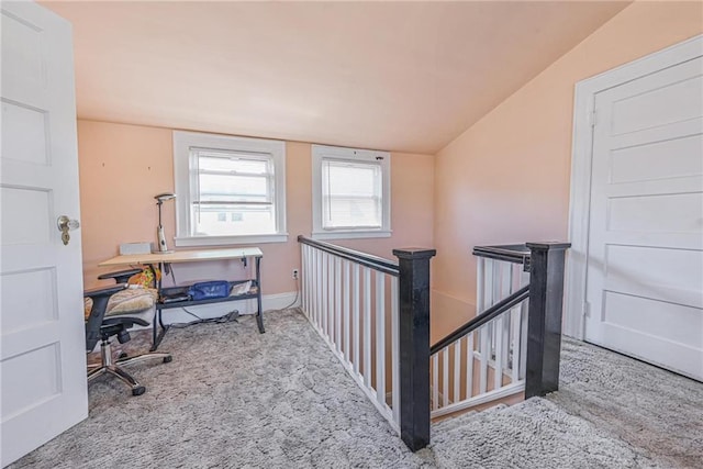 carpeted office with lofted ceiling