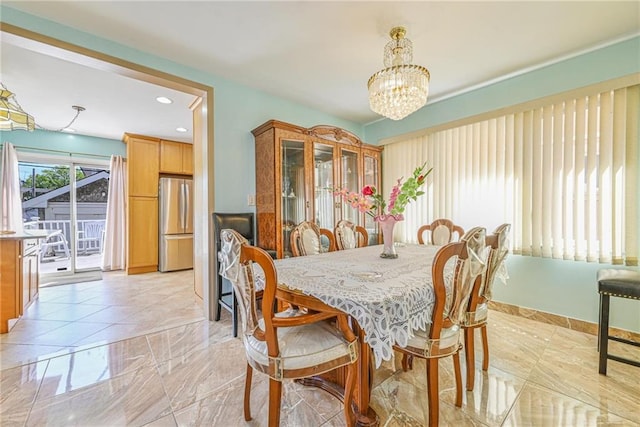 dining area with recessed lighting and a chandelier
