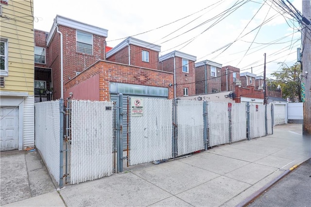 exterior space featuring a gate, a fenced front yard, and a garage