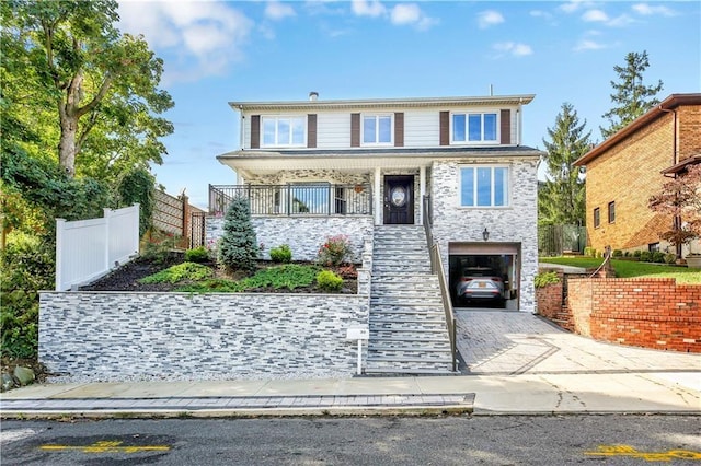30 Beverly Rd, Staten Island, NY 10305 - view of front of house with a garage, stone siding, driveway, and a porch