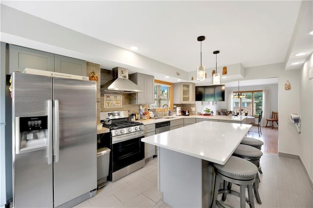 30 Beverly Rd, Staten Island, NY 10305 - kitchen with stainless steel appliances, wall chimney exhaust hood, healthy amount of natural light, a breakfast bar area, and recessed lighting