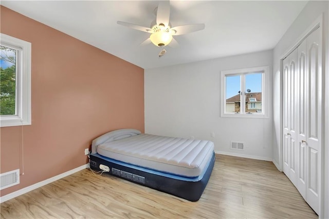 30 Beverly Rd, Staten Island, NY 10305 - bedroom with multiple windows, a closet, ceiling fan, and wood finished floors