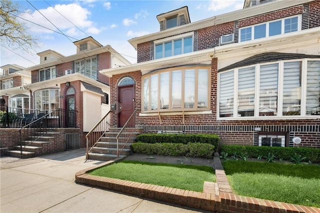 rear view of property with brick siding