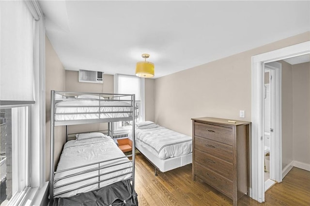 bedroom with baseboards and wood finished floors