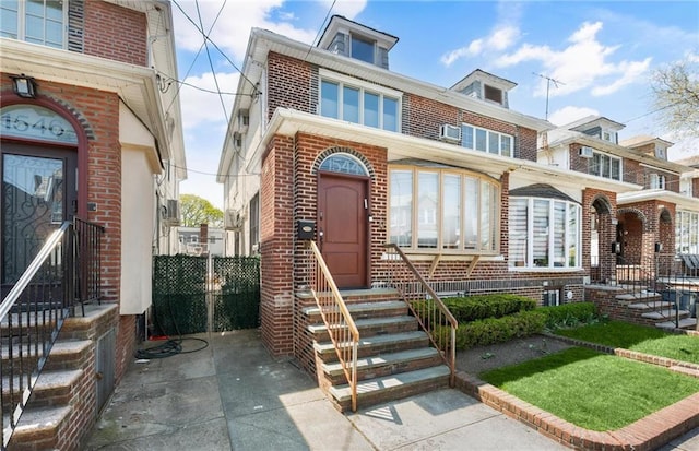 view of front of house with brick siding and entry steps