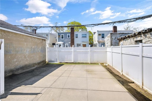 view of patio / terrace featuring a fenced backyard and a residential view