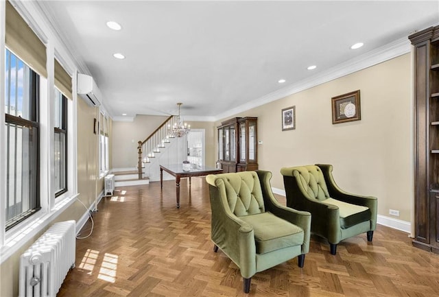 sitting room featuring baseboards, a wall mounted air conditioner, radiator, and a notable chandelier