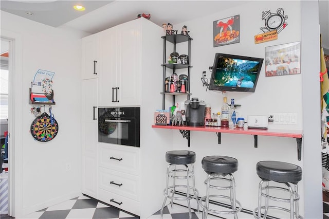 bar with tile patterned floors, recessed lighting, and oven