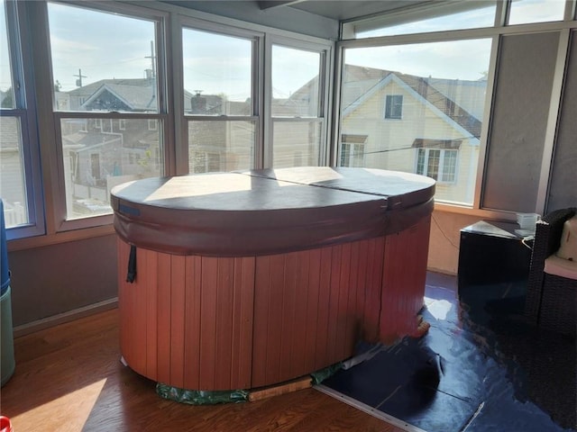 sunroom featuring a hot tub