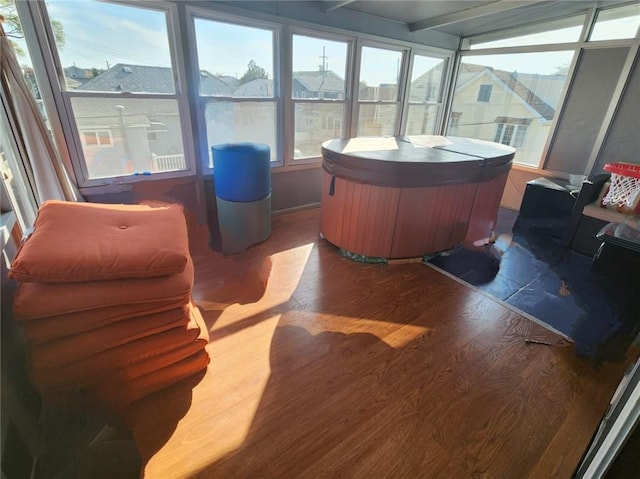 sunroom featuring a jacuzzi and wood finished floors