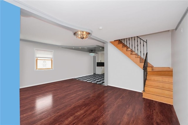 below grade area with baseboards, stairway, and wood finished floors