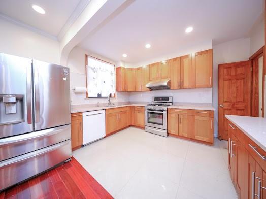 299 Bay 13th St, Brooklyn, NY 11214 - kitchen featuring stainless steel appliances, under cabinet range hood, light countertops, recessed lighting, and a sink