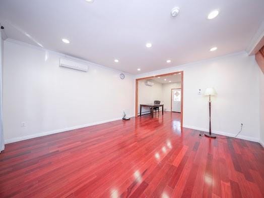 299 Bay 13th St, Brooklyn, NY 11214 - basement with a wall mounted air conditioner, wood finished floors, recessed lighting, and baseboards