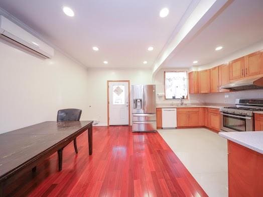 299 Bay 13th St, Brooklyn, NY 11214 - kitchen with stainless steel appliances, under cabinet range hood, a wall mounted air conditioner, light countertops, and recessed lighting