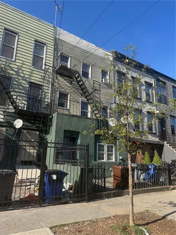 view of building exterior with a fenced front yard