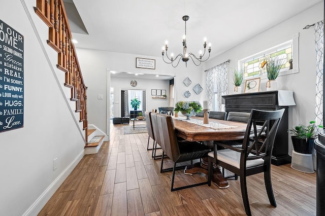 1142 Bay Ridge Parkway, Brooklyn, NY 11228 - dining space featuring stairway, a chandelier, wood finished floors, and baseboards