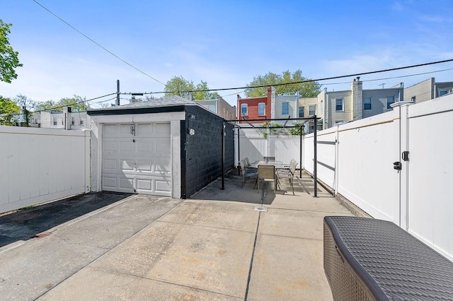 1142 Bay Ridge Parkway, Brooklyn, NY 11228 - fenced backyard featuring an outdoor structure, a garage, outdoor dining space, and a patio