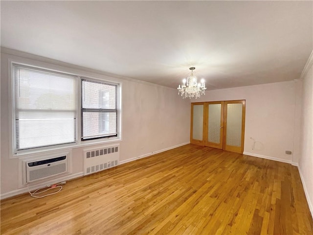 3101 Ocean Pkwy Unit 4O, Brooklyn, NY 11235 - spare room with radiator, a chandelier, light wood-style flooring, an AC wall unit, and baseboards