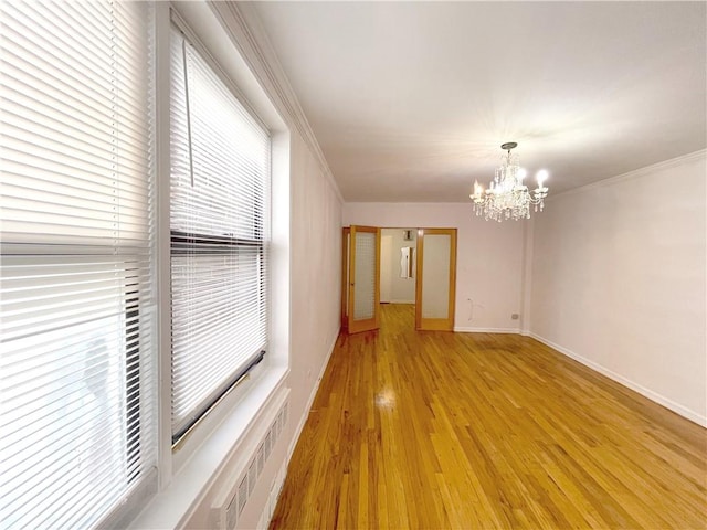 3101 Ocean Pkwy Unit 4O, Brooklyn, NY 11235 - spare room featuring a chandelier, light wood finished floors, crown molding, and baseboards