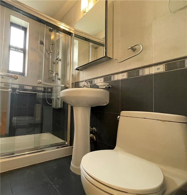 3101 Ocean Pkwy Unit 4O, Brooklyn, NY 11235 - bathroom featuring toilet, a stall shower, tile patterned flooring, and tile walls
