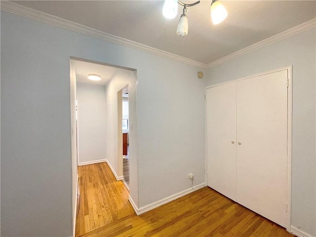 3101 Ocean Pkwy Unit 4O, Brooklyn, NY 11235 - unfurnished bedroom with wood finished floors, ornamental molding, a closet, and baseboards